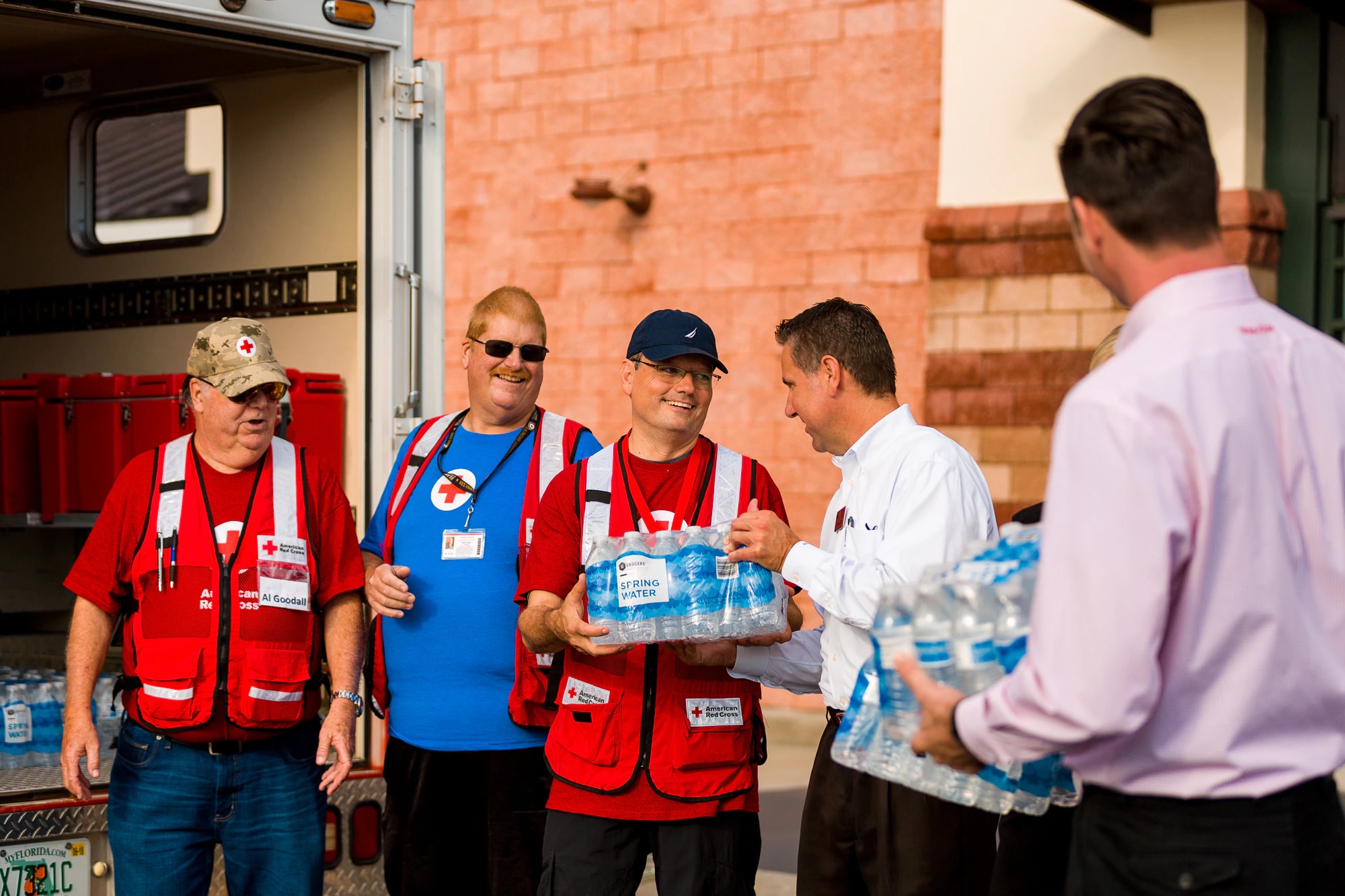 Store associates help the Red Cross load waters into truck