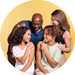 Happy family wearing yellow Fresco y Más pharmacy bandages.