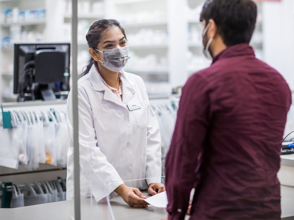 Harveys Pharmacy - Pharmacist Checking Medicines on the rack