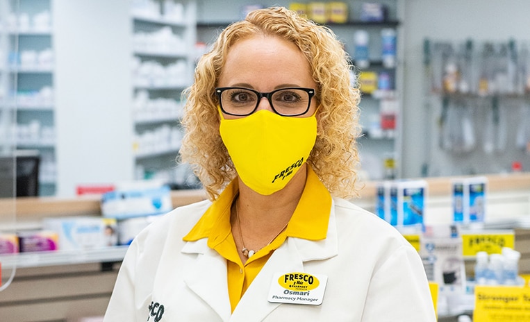 Fresco Y Mas pharmacy manager wearing a yellow face mask