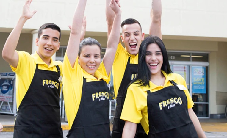 Group of Fresco Y Mas associates cheering with their hands up